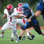 Thunder Mountain's Duane Harwell, right,  puts pressure on Kenai's quarterback Chase Gillies at TMHS on Friday. Kenai won the game 23-12.