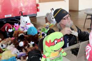 Toy Run organizer Brillo accepts donations at the Douglas Firehall Sunday, August 21. It was the 22nd year for the annual Bob Valliant Toy Run. Douglas Volunteer Firefighters, Capital City Fire and Rescue, the Triangle Club and Louie's Bar supported the run. The Panhandlers Motorcycle Club rounded up hundreds of soft toys.