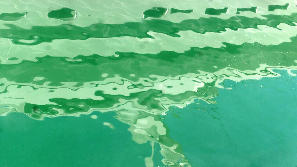 Reflection of a fiberglass yacht in the downtown boat harbor.