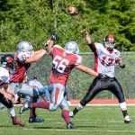 Juneau-Douglas junior quarterback Jonathan-Che Stults (17) evades a rush and passes the ball Saturday, Aug. 27, 2016, during the Crimson Bears' 25-22, double-overtime win against Ketchikan High School at Esther Shea Field in Ketchikan.