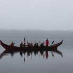 One of the two 40-foot spruce dugout canoes carved in Hoonah by master carver Wayne Price and apprentices Steven Price (Wayne's son), Zack James (Tlél Tooch Tláa.aa) and James Hart (Gooch Éesh) arrives to Bartlett Cove. Around two dozen paddlers made the trip from Hoonah to Glacier Bay in one of three dugout canoes.