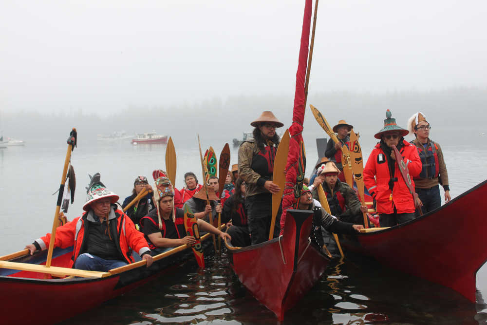 Carver James Hart greets the hundreds gathered on Bartlett Cove's shore in Tlingit. These three boats paddled from Hoonah to Glacier Bay.