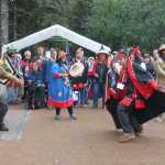 Carvers Zack James, left, and Steven Price, right, dance their way into Xunaa Shuká Hít, accompanied by Hoonah High School student Mary Jack, with drum at left, teacher Heather Powell, and carver James Hart. James, Price and Hart were master carver Wayne Price's three apprentices in the carving of the two 40-foot dugout canoes Huna Tlingit paddled to Glacier Bay.