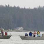 Family members of Arnold Skeek watch from an open skiff, right, as Gene Ralston of Idaho uses his purpose-built boat to find and recovery Skeek's body about a half-mile in front of the Don D. Statter Memorial Boat Harbor in Auke Bay on Monday.