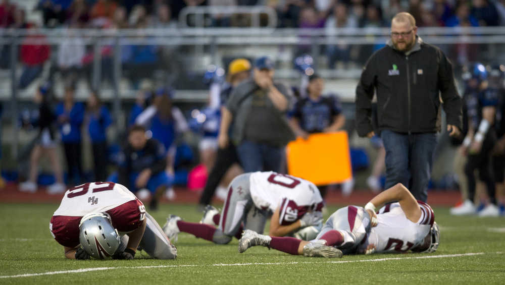 Three Ketchikan players lay on the field after a play in the second quarter at Thunder Mountain High School on Friday. With Thunder Mountain up 21-0 in the second quarter Ketchikan walked off the field citing unfair refereeing after multiple injuries to Ketchikan players. Two Ketchikan players were taken to Bartlett Regional Hospital.