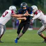Thunder Mountain's quarterback Cale Jenkins is sacked by Ketchikan's Christopher Brown, left, and Stevie Byron, right, at Thunder Mountain High School on Friday. With Thunder Mountain up 21-0 in the second quarter Ketchikan walked off the field citing unfair refereeing after multiple injuries to Ketchikan players. Two Ketchikan players were taken to Bartlett Regional Hospital.