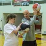 Tammi Birch 38 (left) and former NBA assistant coach for the New York Knicks Greg Brittenham (right) focus on ball handling techniques before taking the shot at "I Did. You Can." Basketball camp for athletes with special needs on Saturday at JDHS Gymnasium.