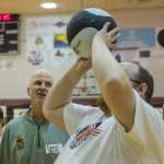 Greg Brittenham (left) former NBA assistant coach with the New York Knicks checks the form of a participant at "I Did. You Can." Bsketball camp for athletes with special needs Saturday at JDHS Gymnasium.