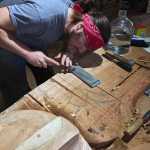 Haida apprentice carver St'igiinii (Harley Holter) works diligently on a totem pole that will be completed later this year.