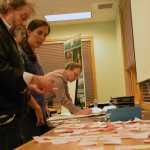 Chris Ouderkirk, Dani Snyder and Christopher Mertl work to identify favorite recreation activities, written on post-it notes, at a planning meeting for the Mendenhall Glacier Recreation Area.