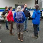Juneau Police Department Officer Jeff Brink, second from right, gives volunteer searchers direction in the search for Ryan Harvey, 22, at the University of Alaska Southeast on Thursday.