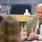 Mayor Ken Koelsch, left, listens to Gov. Bill Walker speak to the Assembly during a special meeting on Thursday.