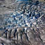 Like the eye of a hurricane, the blue-tinged seracs form a circle in the middle of Norris Glacier.