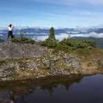A hiker takes a photo at the top of Crystal Mountain, near Petersburg.