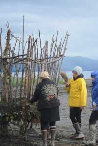 Mavis Muller, left, directs a crew of volunteer artists Monday at construction of this year's Burning Basket, Expand, at Mariner Park.