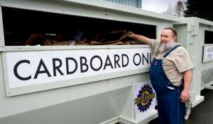 Jim Penor, solid waste coordinator for the city, is happy to see the cardboard bin is nearly full after the new recycling containers at The Alaska Club on Riverside have been in use for a week on Tuesday. The City and Borough of Juneau waste management has rebranded its name to Recycleworks and has three locations for the new containers.