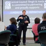 Lt. Kris Sell gives people attending the Juneau Police Department's Coffee with a Cop a briefing Tuesday on the department's search for Christopher Orcutt, 22.