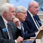 University of Alaska Southeast Chancellor Richard Caulfield, left, Fairbanks Interim Chancellor Dana Thomas, center, and Anchorage Chancellor Tom Case listen and watch the university's Board of Regents meeting at the UAS Recreation Center on Thursday.