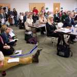 University of Alaska employees and students crowd into a meeting room to listen and watch the university's Board of Regents meeting at the UAS Recreation Center on Thursday.