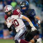 Ketchikan's Cristopher Carlson, left, is chase by Thunder Mountain's Steven Rosales after a pass reception at Thunder Mountain High School on Friday. With Thunder Mountain up 21-0 in the second quarter Ketchikan walked off the field citing unfair refereeing after multiple injuries to Ketchikan players. Two Ketchikan players were taken to Bartlett Regional Hospital.
