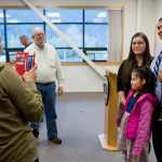 Officer Sean Ahshapanek has his picture taken with long-time partner Barbara Dude and their children, Michelle, 8, and Shaunde, 3, after being sworn into the Juneau Police Department on Friday.