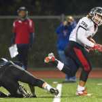 North Pole's Lafi'itione Skipps slips a tackle attempt by Thunder Mountain's Roy Tupou to score at TMHS on Friday. TMHS won 22-20