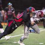 Juneau-Douglas High School's Cristian Batac tackles Ketchikan's Sean Tavares during their game Saturday at Adair Kennedy Memorial Park. JDHS won 24-20.