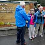 Mayor Ken Ken Koelsch, left, and Lt. Gov. Byron Mallott, right, welcome Wendy Yoisten, with her husband John, of St. Albert, Alberta, as the one millionth cruise ship passenger to arrive for the season in Juneau on Thursday. The Yoisten arrived on the Holland America Line Zaandam.