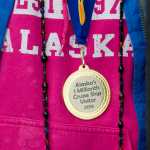 Wendy Yoisten is given a medal as the one millionth cruise ship passenger to arrive for the season in Juneau on Thursday.