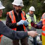 Alexander Bornemann, project manager for cable supplier NSW, second from right, watches International Telecom employees Rick Chislett, left, Kevin DeMont, center, and Davy Chan separate fiber optic cable for testing after it was brought to shore in Haines for the Alaska Power and Telephone Company on Friday. The cable will bring more bandwidth to the upper Lynn Canal communities of Haines and Skagway.