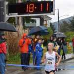 Juneau-Douglas High School freshman Sadie Tuckwood breaks the tape as the winner of Saturday's Region V girls 4A cross country championship meet in Sitka.