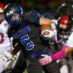 Thunder Mountain's Roy Tupou is tackled by Juneau-Douglas' Lance Galletes-Flagatusa in a cross town conference game at TMHS on Friday. TMHS won the game.