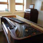 A 173-year-old piano which will be given a glass top and turned into a kitchen island at Rainforest Custom on Sept. 27.