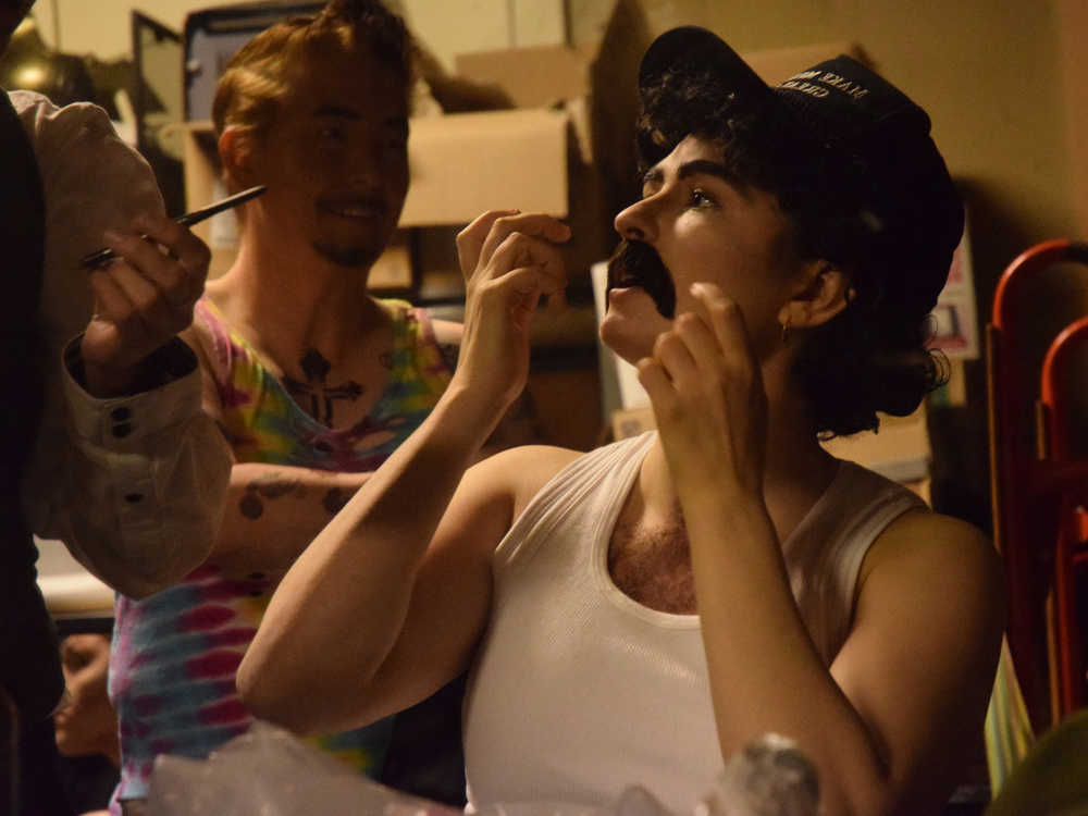 Marty Weiner, played by Annie Bartholomew, finishes applying his moustache before the start of the Femme Fatale drag-show fundraiser Friday, Sept. 30, 2016.