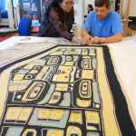 Chilkat weaver Anna Brown Ehlers and her apprentice Darrell J. Harmon add fringe to the diving whale blanket at the Alaska State Museum's conservation lab on Sept. 28.