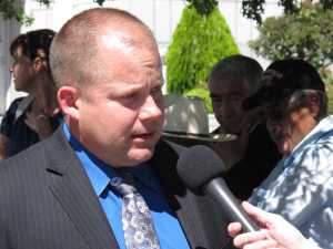 Members of the Pyramid Lake Paiute Tribe and Walker River Paiute Tribe talk in the background outside the federal courthouse as their lawyer, Rendal Miller, discusses the lawsuit they filed under the Voting Rights Act of 1965 on Wednesday in Reno, Nevada.