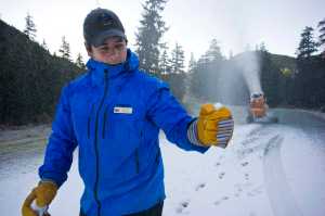 Eaglecrest General Manager Matt Lillard checks the quality of the snow while running a snow making machine for the first time this season on Tuesday. The temperature was about 29 degrees.