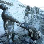 Artist Sarah Davies welcomes people to the opening of her 100Stone project on the beach at Point Woronzof in Anchorage on  Dec. 5, 2015. The enormous project aims to shine a light on the struggles people have with mental health issues.