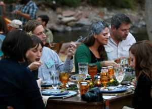 In this Oct. 2, 2016 photo, diners smoke marijuana as they eat dishes prepared by chefs during an evening of pairings of fine food and craft marijuana strains served to invited guests dining at Planet Bluegrass, an outdoor venue in Lyons, Colo. Chefs and pot growers trying to explore fine dining with weed face a legal gauntlet to make pot dinners a reality, even where the drug is legal. (AP Photo/Brennan Linsley)