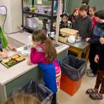 Life Skills Teacher Jessica Kovach demonstrates how to make a grilled cheese sandwich at Dzantik'i Heeni Middle School on Thursday.