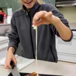 Eighth-grader Taylor Bentley examines her grilled-cheese sandwich during a Life Skills class at Dzantik'i Heeni Middle School on Thursday.