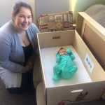 Kaity Conrad by her daughter Amelia who rests in a baby box given out by Bartlett Regional Hospital Foundation.