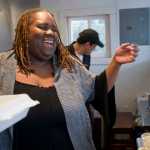 Jocelyn Miles, owner of Spuds-A-Plenty, and employee Cesar Bedillo serve food from "the spud shack" located behind the Juneau Job Center on Egan Drive on Friday.