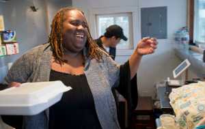 Jocelyn Miles, owner of Spuds-A-Plenty, and employee Cesar Bedillo serve food from "the spud shack" located behind the Juneau Job Center on Egan Drive on Friday.