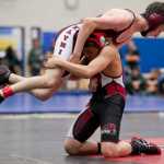 Juneau-Douglas' Ricky Ramirez lifts Ketchikan's Connor McCormick during their 106 weight bout in the Brandon Pilot Tournament at TMHS on Friday.