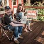 Mark Vinsel and Dianne Anderson pose by their artwork at Gruening's Cabin.