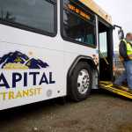 Bob Vos, maintenance supervisor for Capital Transit, shows the lower wheelchair ramp on one of the four new buses the city will put into service by December.