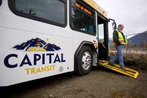 Bob Vos, maintenance supervisor for Capital Transit, shows the lower wheelchair ramp on one of the four new buses the city will put into service by December.