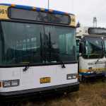 One of four new buses, left, sits next to an older bus with over 600,000 miles on it.