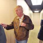 Libertarian vice presidential nominee Bill Weld speaks with a supporter prior to addressing a campaign rally Friday in Anchorage. Campaign consultant Apollo Pazell is at right.